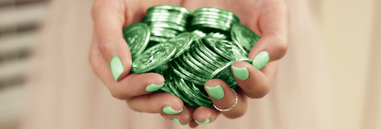 Hand holding green coins.