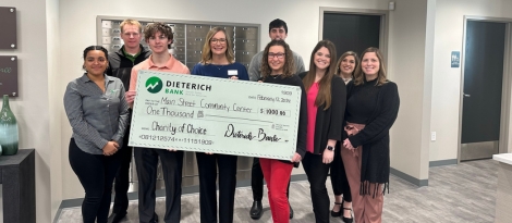 Dieterich Bank Team posing with members of the Main St Community Center.