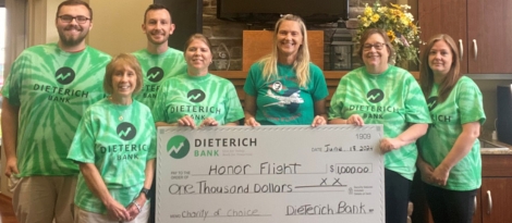 Dieterich Bank Employees pose with Honor Flight volunteers during $1,000 check presentation.