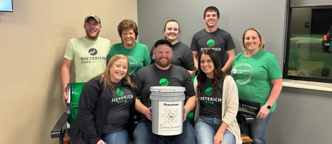 Group of Teutopolis Dieterich Bank employees posing with Teutopolis Tips for Tomorrow bucket after volunteering.