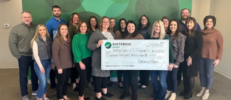Large group of Dieterich Bank employees and United Way representatives with check for 2024 donations.