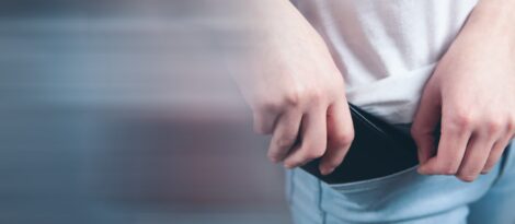 man putting wallet in pocket
