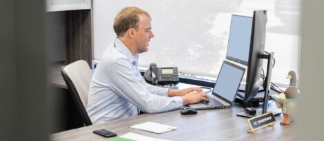 Business Owner working on his laptop at his desk.
