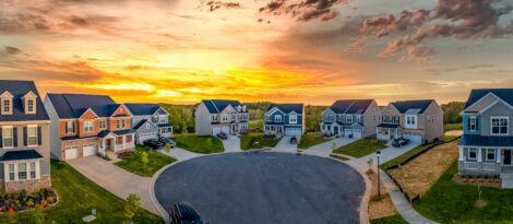 Cul-de-sac of new homes with sunset in background.